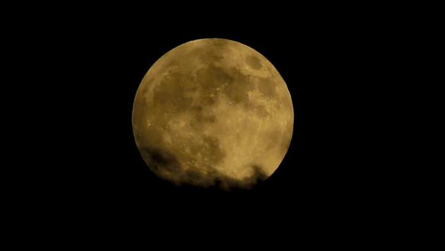 “It’s called a blood moon because the light from the sun goes through the Earth’s atmosphere on its way to the moon, and the Earth’s atmosphere turns it red in the same way that when the sun goes down it goes red,” said Andrew Fabian, professor of astronomy at the University of Cambridge. (Mahmud Hams / AFP)