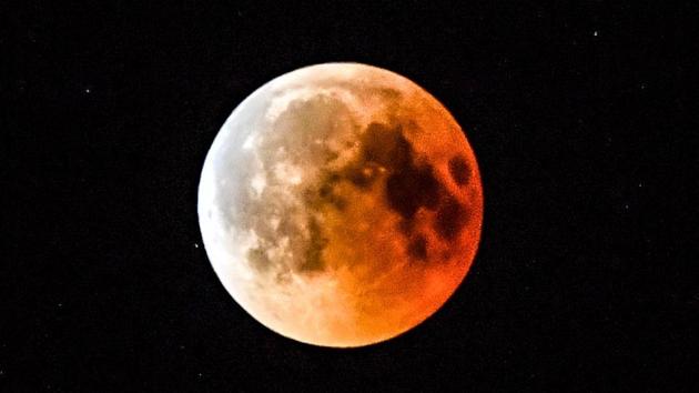 This picture shows the full moon during a 'blood moon' eclipse as seen from the eastern Turkey city of Tunceli on July 27, 2018.(AFP)