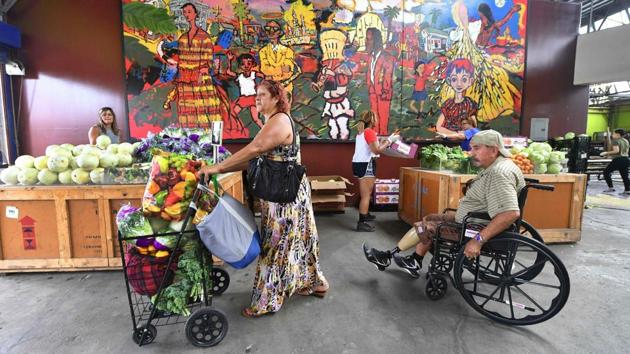 Paula Ramirez pushes her cart full of free fruit and vegetables on offer at a twice monthly food distribution effort . “This food is so good. I don’t understand why they were going to throw it away,” said Ramirez. She saves a lot of money thanks to this charity, and she needs to: her husband uses a wheelchair and they get by on a small pension. “He doesn’t work and neither do I,” she said. (Frederic J. Brown / AFP) Paula Ramirez pushes her cart full of free fruit and vegetables on offer at a twice monthly food distribution effort . “This food is so good. I don’t understand why they were going to throw it away,” said Ramirez. She saves a lot of money thanks to this charity, and she needs to: her husband uses a wheelchair and they get by on a small pension. “He doesn’t work and neither do I,” she said. (Frederic J. Brown / AFP)