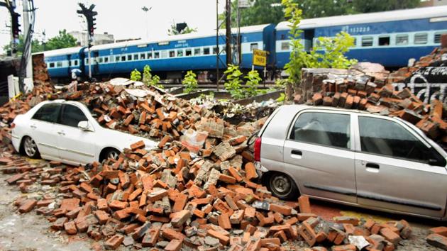 Damaged vehicles are seen after a boundary wall of Ghaziabad Railway Station collapsed due to monsoon rainfall, near Goushala Underpass in Ghaziabad. 116 families of Vartalok and Pragya Kunj housing societies were affected in Ghaziabad after a road caved in, on Thursday. (PTI) Damaged vehicles are seen after a boundary wall of Ghaziabad Railway Station collapsed due to monsoon rainfall, near Goushala Underpass in Ghaziabad. 116 families of Vartalok and Pragya Kunj housing societies were affected in Ghaziabad after a road caved in, on Thursday. (PTI)
