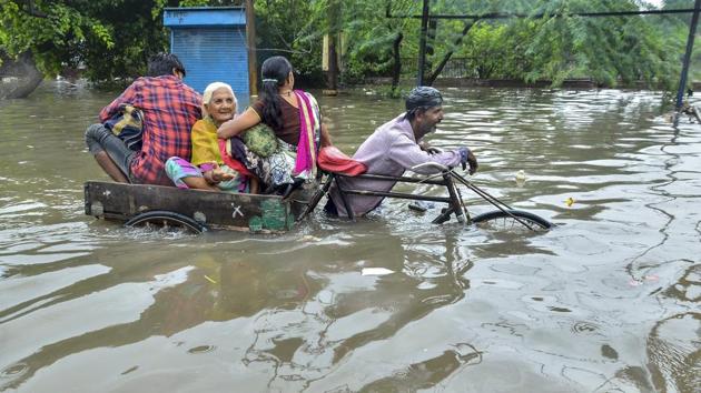 A rickshaw puller ferries his passengers through a waterlogged street during heavy rain in Mathura, Uttar Pradesh. As many as 49 people have lost their lives in rain-related incidents in Uttar Pradesh since Thursday, with Saharanpur accounting for the maximum 11 deaths, as heavy rains wreaked havoc in different parts of the country. (PTI) A rickshaw puller ferries his passengers through a waterlogged street during heavy rain in Mathura, Uttar Pradesh. As many as 49 people have lost their lives in rain-related incidents in Uttar Pradesh since Thursday, with Saharanpur accounting for the maximum 11 deaths, as heavy rains wreaked havoc in different parts of the country. (PTI)