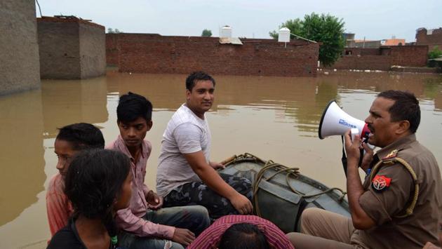 An officer makes announcement as he rescues the local residents who were struck during a flood-like situation after rainfall, at Mira Vihar Colony in Agra. Rains also damaged an outer boundary wall of the 16th century Fatehpur Sikri fort, west of Agra. However, there was no damage to the main monument, said an official, P.K. Singh. (PTI) An officer makes announcement as he rescues the local residents who were struck during a flood-like situation after rainfall, at Mira Vihar Colony in Agra. Rains also damaged an outer boundary wall of the 16th century Fatehpur Sikri fort, west of Agra. However, there was no damage to the main monument, said an official, P.K. Singh. (PTI)