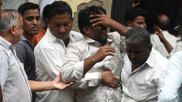 Relatives of one of the victims, Jayant Chaugule mourn on his death at the rural hospital in the Raigad district. (PRATHAM GOKHALE/HT PHOTO) 