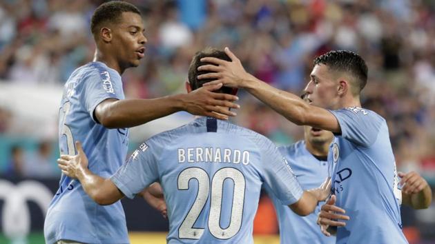 Manchester City midfielder Bernardo Silva is congratulated by teammates after scoring a goal against Bayern Munich.(AP)