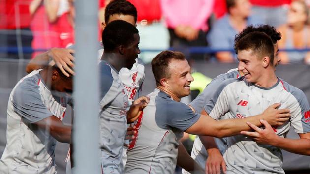 Liverpool's Xherdan Shaqiri celebrates with team mates after scoring a goal against Manchester United.(REUTERS)