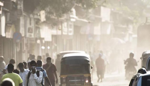 People walk through dust created by roadwork in Mumbai. (Pratik Chorge/HT Photo) People walk through dust created by roadwork in Mumbai. (Pratik Chorge/HT Photo)