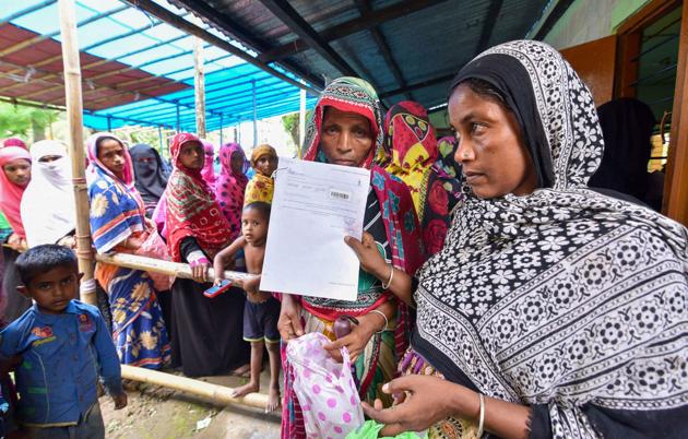 People wait to check their names on the final draft of the state's National Register of Citizens after it was released, at an NRC Seva Kendra in Nagaon on Monday, July 30, 2018.(PTI Photo)