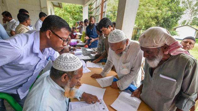 People check their names on the final draft of the state's National Register of Citizens after it was released, at a NRC Seva Kendra in Nagaon, July 30(PTI)