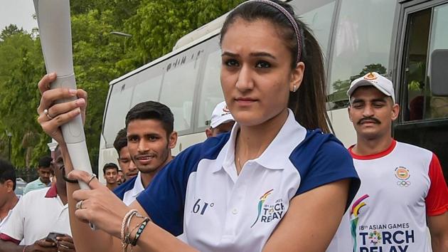 Indian table tennis player Manika Batra runs holding the torch during the 'Torch Relay' for the Asian Games 2018.(PTI)
