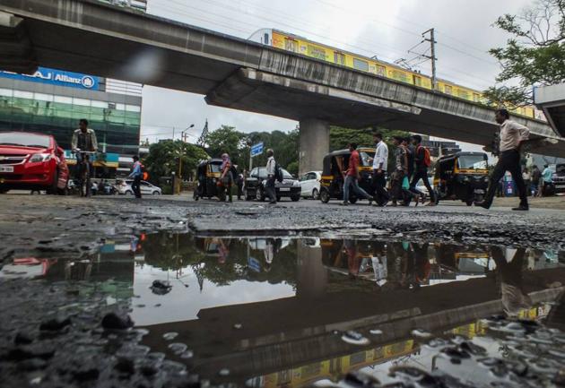 The complaint about potholes near the Western Express Highway Metro station in Andheri (east) remains unattended.(Ragul Krishnan/ HT Photo)