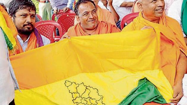 Protesters demanding separate statehood for 13 districts of north Karnataka unveil a regional flag in Belagavi on Tuesday. (HT Photo) Protesters demanding separate statehood for 13 districts of north Karnataka unveil a regional flag in Belagavi on Tuesday. (HT Photo)