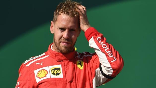 Ferrari's German Driver Sebastian Vettel reacts as he celebrates on the podium after the Hungarian GP.(AFP)