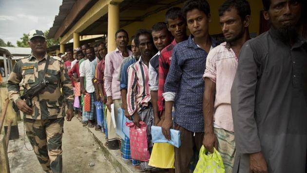 People stand in a queue to check if their names are included in the National Register of Citizens at a draft centre in Bur Gaon village, India, Monday, July 30, 2018. India on Monday released a final draft of a list of its citizens in Assam.(AP Photo)