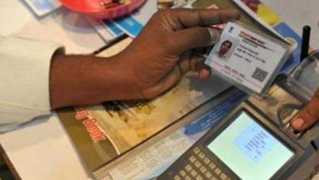 A visitor gives a thumb impression to withdraw money from his bank account with his Aadhaar or Unique Identification (UID) card during a Digi Dhan Mela, held to promote digital payment, in Hyderabad on January 18, 2017. (AFP) A visitor gives a thumb impression to withdraw money from his bank account with his Aadhaar or Unique Identification (UID) card during a Digi Dhan Mela, held to promote digital payment, in Hyderabad on January 18, 2017. (AFP)