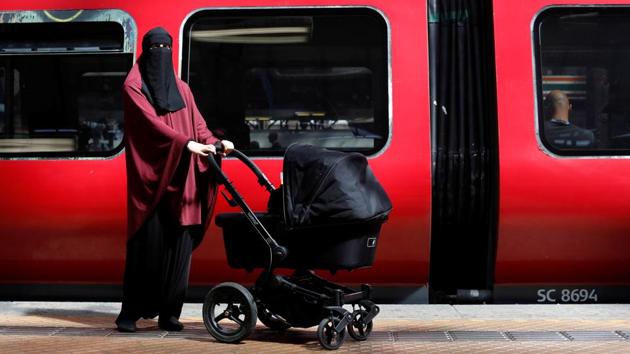Sarah, 30, poses for a portrait. She stands at the spot, where she said, a man screamed anti-Islamic obscenities at her while almost forcing her onto the train tracks as she cradled her then two-week-old baby. (Andrew Kelly / Reuters) Sarah, 30, poses for a portrait. She stands at the spot, where she said, a man screamed anti-Islamic obscenities at her while almost forcing her onto the train tracks as she cradled her then two-week-old baby. (Andrew Kelly / Reuters)