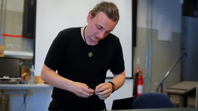 Mathias Vidas Olsen, 29, a viking-age replica jewellery maker, demonstrates the preparation of bracelets he designed with a phrase that translates to “I will go with the burqa, will you?” in Copenhagen. “I’m not for or against the niqab,” Olsen said. “I’m for the right of the people to wear whatever they want whether they be a Muslim or a punk,” he added. (Andrew Kelly / Reuters) Mathias Vidas Olsen, 29, a viking-age replica jewellery maker, demonstrates the preparation of bracelets he designed with a phrase that translates to “I will go with the burqa, will you?” in Copenhagen. “I’m not for or against the niqab,” Olsen said. “I’m for the right of the people to wear whatever they want whether they be a Muslim or a punk,” he added. (Andrew Kelly / Reuters)