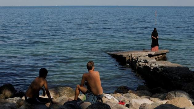 Swimmers watch on as Anna-Bella, 26, who was born in Peru and converted to Islam at age 20, walks along the seafront in Copenhagen, Denmark. In May, the Danish parliament banned the wearing of face veils in public, joining France and some other European countries to uphold what some politicians say are secular and democratic values. (Andrew Kelly / Reuters) Swimmers watch on as Anna-Bella, 26, who was born in Peru and converted to Islam at age 20, walks along the seafront in Copenhagen, Denmark. In May, the Danish parliament banned the wearing of face veils in public, joining France and some other European countries to uphold what some politicians say are secular and democratic values. (Andrew Kelly / Reuters)
