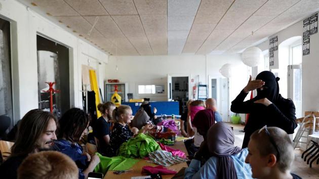 Mizgan, 24, advises attendees on how to prepare a face veil during a workshop. (Andrew Kelly / Reuters) Mizgan, 24, advises attendees on how to prepare a face veil during a workshop. (Andrew Kelly / Reuters)