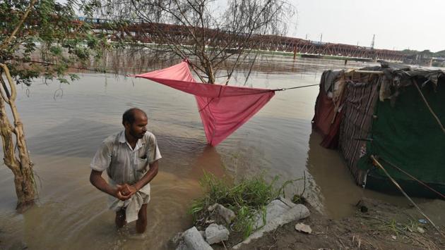 The evacuation of people living on the riverbed, which started on Saturday, has resulted in the shifting of over 10,000 people. “More people are being shifted as the water level is rising and the situation is severe. Some people are not willing to shift, but we are trying to persuade them,” an official of the Flood Control Department said. (Raj K Raj / HT Photo) The evacuation of people living on the riverbed, which started on Saturday, has resulted in the shifting of over 10,000 people. “More people are being shifted as the water level is rising and the situation is severe. Some people are not willing to shift, but we are trying to persuade them,” an official of the Flood Control Department said. (Raj K Raj / HT Photo)