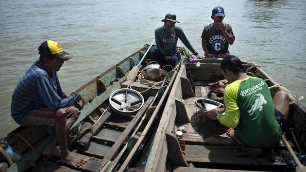 But the divers’ fate is in limbo as urban development threatens their riverside community, which stands on weathered wooden stilts. Bangkok officials have ordered the families to relocate away from the river as part of the junta government’s gentrification plan for the city. (Sippachai Kunnuwong / AFP)