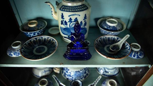 A Buddha statue and China ceramic set retrieved by the divers. “We don’t know what we will find or where we will go today,” said Somsak Ongsaard. “It’s exciting,” added the 29-year-old diver. (Sippachai Kunnuwong / AFP)