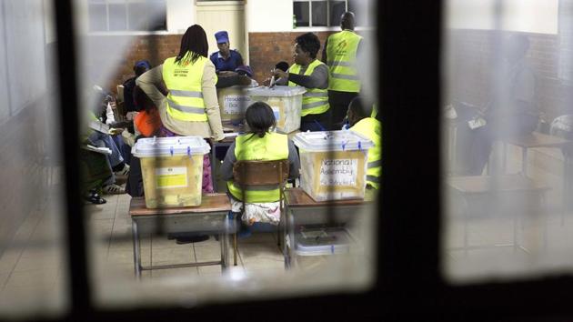 Vote counting starts at a polling station in Bulawayo, Zimbabwe. “If this guy loses there is no way they will handover power,” said Gift Machekera, pointing at a huge banner of Mnangagwa hanging on a building in Harare. “Those who have the guns have the power. This is Africa,” added Machekera. (Jerome Delay / AP) Vote counting starts at a polling station in Bulawayo, Zimbabwe. “If this guy loses there is no way they will handover power,” said Gift Machekera, pointing at a huge banner of Mnangagwa hanging on a building in Harare. “Those who have the guns have the power. This is Africa,” added Machekera. (Jerome Delay / AP)