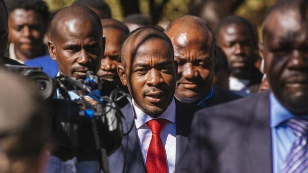 Nelson Chamisa, leader of the Movement for Democratic Change (MDC), center, arrives to cast his vote at a polling station in the Kuwadzana township, in Harare, Zimbabwe. “We should be very clear as to an emphatic voice for change, the new, and the young -- I represent that,” Chamisa said as he voted, surrounded by vocal supporters. (Waldo Swiegers / Bloomberg) Nelson Chamisa, leader of the Movement for Democratic Change (MDC), center, arrives to cast his vote at a polling station in the Kuwadzana township, in Harare, Zimbabwe. “We should be very clear as to an emphatic voice for change, the new, and the young -- I represent that,” Chamisa said as he voted, surrounded by vocal supporters. (Waldo Swiegers / Bloomberg)