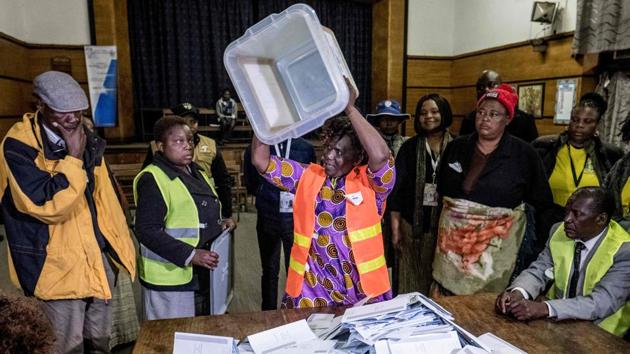 An electoral worker empties a presidential candidates ballot box onto a table during counting operations. The winner faces the task of putting Zimbabwe back on track after 37 years under Mugabe which were tainted by corruption, mismanagement and diplomatic isolation that caused a crisis in a country that once had one of Africa’s most promising economies. (Marco Longari / AFP) An electoral worker empties a presidential candidates ballot box onto a table during counting operations. The winner faces the task of putting Zimbabwe back on track after 37 years under Mugabe which were tainted by corruption, mismanagement and diplomatic isolation that caused a crisis in a country that once had one of Africa’s most promising economies. (Marco Longari / AFP)
