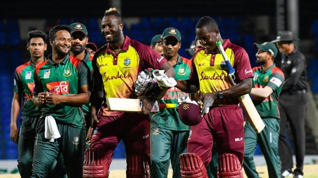 Shakib Al Hasan (L) of Bangladesh, Andre Russell (C) and Rovman Powell (R) of West Indies smile at the end of the 1st T20i match between West Indies and Bangladesh at Warner Park, Basseterre.(AFP)