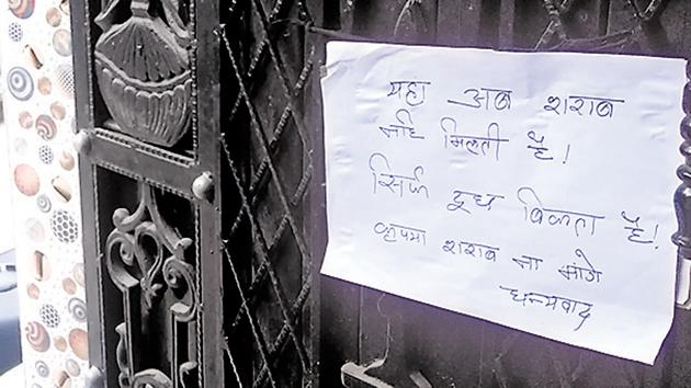 A woman who gave up bootlegging to take up dairy business pastes a notice outside her house in south Delhi's Sangam Vihar.(HT Photo)