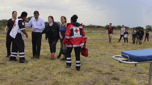 Red Cross workers attend to passengers as they walk away from an Aeromexico jetliner that crashed near the airport in Durango, Mexico on Tuesday. (AP photo) Red Cross workers attend to passengers as they walk away from an Aeromexico jetliner that crashed near the airport in Durango, Mexico on Tuesday. (AP photo)