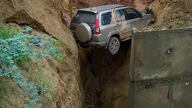 Four people had a narrow escape after their car fell into a nearly 20-feet deep ditch created after a portion of a service road caved in along the Agra-Lucknow Expressway on Wednesday morning following heavy rains, police said. The state government asked railways consultancy firm RITES Limited to carry out an inquiry into the incident and submit its report within 15 days. (PTI) Four people had a narrow escape after their car fell into a nearly 20-feet deep ditch created after a portion of a service road caved in along the Agra-Lucknow Expressway on Wednesday morning following heavy rains, police said. The state government asked railways consultancy firm RITES Limited to carry out an inquiry into the incident and submit its report within 15 days. (PTI)