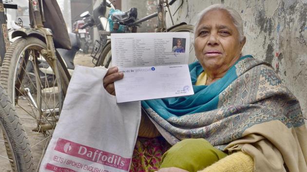 A woman waits outside a bank in Amritsar, Punjab. The gender disparities faced by women get exacerbated in old age since the woman often has no income or assets and is completely dependent on her family.(Sameer Sehgal/Hindustan Times)