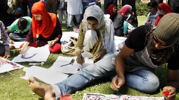 Kashmir University students make artwork during a protest. (HT File Photo) Kashmir University students make artwork during a protest. (HT File Photo)