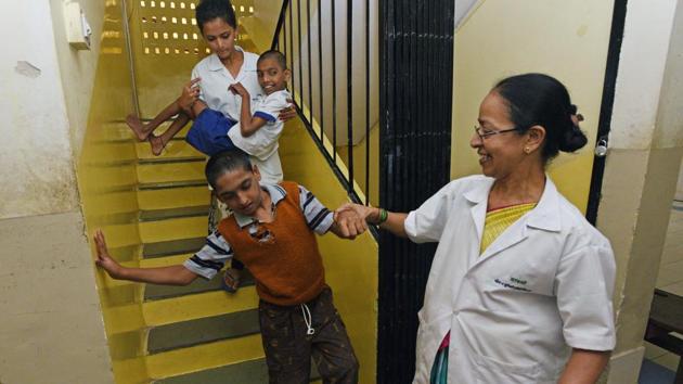 Staff at the Savali centre help specially abled residents in Pune. 81-year-old Vasant Thakar opted for retirement in 1992, and converted his three-storey bungalow and later a plot in Pune into residential homes for special children under a trust called Savali, Marathi for ‘shelter’. The homes now house 50. “My daughter was my sole concern in the beginning, but now I have people as old as 67 living a better life here,” Thakar says. (Pratham Gokhale / HT Photo) 