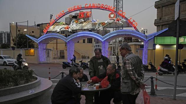 People play Chinese chess in front of the club’s entrance. Dog races were held here in Macau for half a century, up to five nights a week — a constant in this former Portuguese colony even as high-stakes casinos and concert venues sprouted up to offer newer, glitzier entertainment options. (Kin Cheung / AP) People play Chinese chess in front of the club’s entrance. Dog races were held here in Macau for half a century, up to five nights a week — a constant in this former Portuguese colony even as high-stakes casinos and concert venues sprouted up to offer newer, glitzier entertainment options. (Kin Cheung / AP)