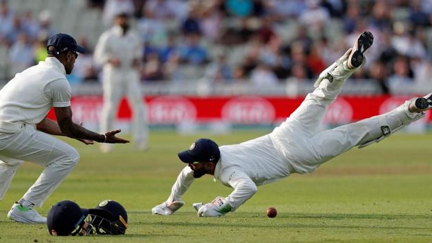 India's wicket keeper Dinesh Karthik (R) dives in front of 1st slip Shikhar Dhawan (L) in an attempt to catch England's Sam Curran on the first day of the first Test cricket match between England and India at Edgbaston. (AFP)