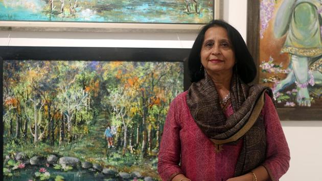 Artist Nisha Dial poses next to her artworks at her exhibition(Shivam Saxena?HT Photo)