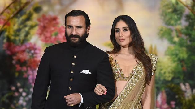 Indian Bollywood actors Saif Ali Khan and wife Kareena Kapoor Khan pose for a picture during the wedding reception of actress Sonam Kapoor and businessman Anand Ahuja in Mumbai.(AFP)