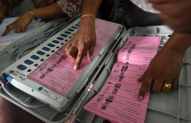 A polling staff tallies the candidates’ names on the Electronic Voting Machines (EVM) during Karnataka elections, in Bengaluru, May 11, 2018. While many developed countries are studying India’s electronic voting system, many parties in India want to go back to the paper ballot.(Arijit Sen/HT Photo) A polling staff tallies the candidates’ names on the Electronic Voting Machines (EVM) during Karnataka elections, in Bengaluru, May 11, 2018. While many developed countries are studying India’s electronic voting system, many parties in India want to go back to the paper ballot.(Arijit Sen/HT Photo)