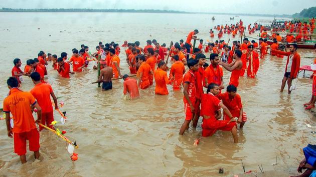 Kanwariyas take a dip in the river Ganga on the first day of holy month of Shravan, at Vindhyachal dham in Mirzapur.(PTI Photo) Kanwariyas take a dip in the river Ganga on the first day of holy month of Shravan, at Vindhyachal dham in Mirzapur.(PTI Photo)