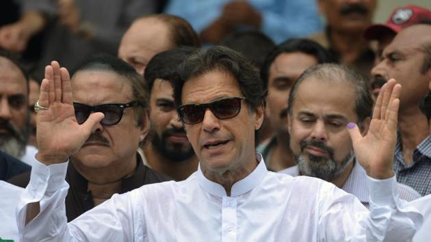 Imran Khan of the Pakistan Tehreek-e-Insaf (Movement for Justice) speaks to the media after casting his vote at a polling station during the general election in Islamabad on July 25, 2018. (AFP) Imran Khan of the Pakistan Tehreek-e-Insaf (Movement for Justice) speaks to the media after casting his vote at a polling station during the general election in Islamabad on July 25, 2018. (AFP)