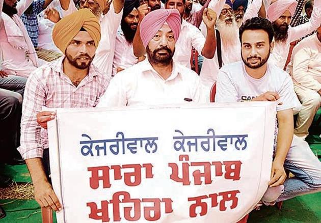 Party workers holding a banner in support of Sukhpal Singh Khaira during the convention in Bathinda. (Bharat Bhushan/ht) Party workers holding a banner in support of Sukhpal Singh Khaira during the convention in Bathinda. (Bharat Bhushan/ht)