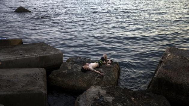 A man rests in front of the sea during a hot summer day in Barcelona, Spain. Hot air from Africa is bringing a new heatwave to Europe, prompting health warnings about Sahara Desert dust and exceptionally high temperatures that are forecast to peak at 47 degrees Celsius (116.6 Fahrenheit) in some southern areas. (Emilio Morenatti / AP) A man rests in front of the sea during a hot summer day in Barcelona, Spain. Hot air from Africa is bringing a new heatwave to Europe, prompting health warnings about Sahara Desert dust and exceptionally high temperatures that are forecast to peak at 47 degrees Celsius (116.6 Fahrenheit) in some southern areas. (Emilio Morenatti / AP)