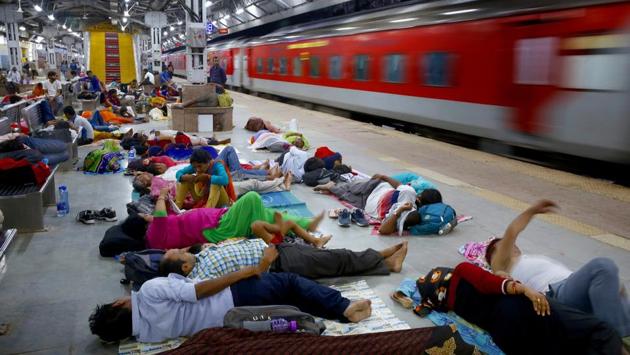 Candidates appearing for Uttar Pradesh state high school teachers examinations sleep on a platform after arriving at a railway station past midnight in Allahabad on July 29, 2018. (Rajesh Kumar Singh / AP) Candidates appearing for Uttar Pradesh state high school teachers examinations sleep on a platform after arriving at a railway station past midnight in Allahabad on July 29, 2018. (Rajesh Kumar Singh / AP)
