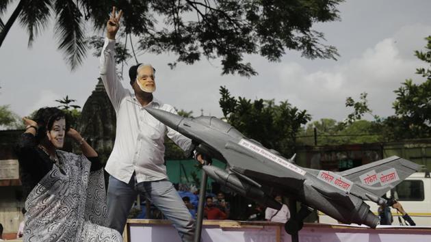 Congress party activists wearing masks of Prime Minister Narendra Modi, (2nd L) and Defence Minister Nirmala Sitharaman, (L), shout slogans accusing the government for buying 36 Rafale fighter aircraft from France at a highly inflated price during a protest in Mumbai, Maharashtra on July 30, 2018. (Rafiq Maqbool / AP) Congress party activists wearing masks of Prime Minister Narendra Modi, (2nd L) and Defence Minister Nirmala Sitharaman, (L), shout slogans accusing the government for buying 36 Rafale fighter aircraft from France at a highly inflated price during a protest in Mumbai, Maharashtra on July 30, 2018. (Rafiq Maqbool / AP)