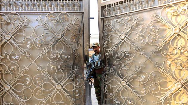 An Afghan security guard stands at the gate of a midwife training center after an attack in Jalalabad city, Afghanistan. (Parwiz / REUTERS) An Afghan security guard stands at the gate of a midwife training center after an attack in Jalalabad city, Afghanistan. (Parwiz / REUTERS)