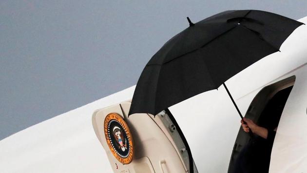 A member of the crew of Air Force One holds an umbrella after US President Donald Trump boarded the plane as he departs Washington to Wilkes Barre, Pennsylvania at Joint Base Andrews in Maryland. (Carlos Barria / REUTERS) A member of the crew of Air Force One holds an umbrella after US President Donald Trump boarded the plane as he departs Washington to Wilkes Barre, Pennsylvania at Joint Base Andrews in Maryland. (Carlos Barria / REUTERS)