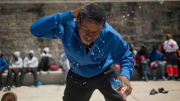 A man cools off upon arrival at the harbour of Tarifa. Just since Friday more than 1,500 migrants have landed in the southern province of Cadiz in Andalusia, with the majority of the arrivals funnelling through Algeciras. But as more migrants make their way to Spain, both through land and water-- authorities are struggling to cope with the sudden spike in arrivals. (Jorge Guerrero / AFP)