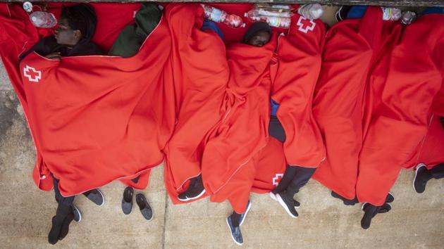 With police stations and makeshift emergency shelters set up in sports centres in Cadiz full, many rescued migrants were forced to sleep inside an orange rescue boat docked in the port of Algeciras, or on the pavement beside it. (Marcos Moreno / AP)